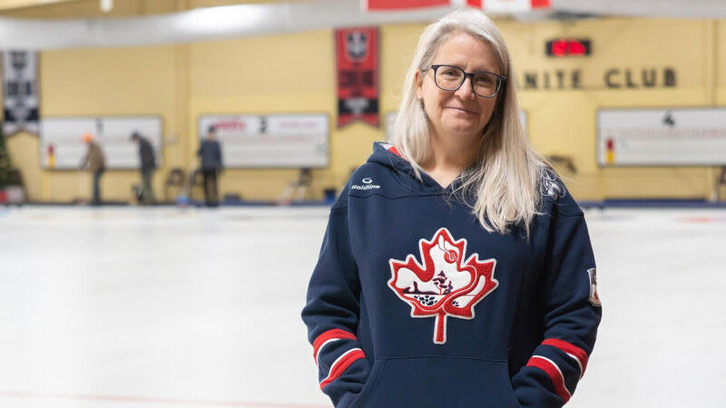 Heather Mair stands beside curling sheets at Waterloo’s Granite Curling Cl